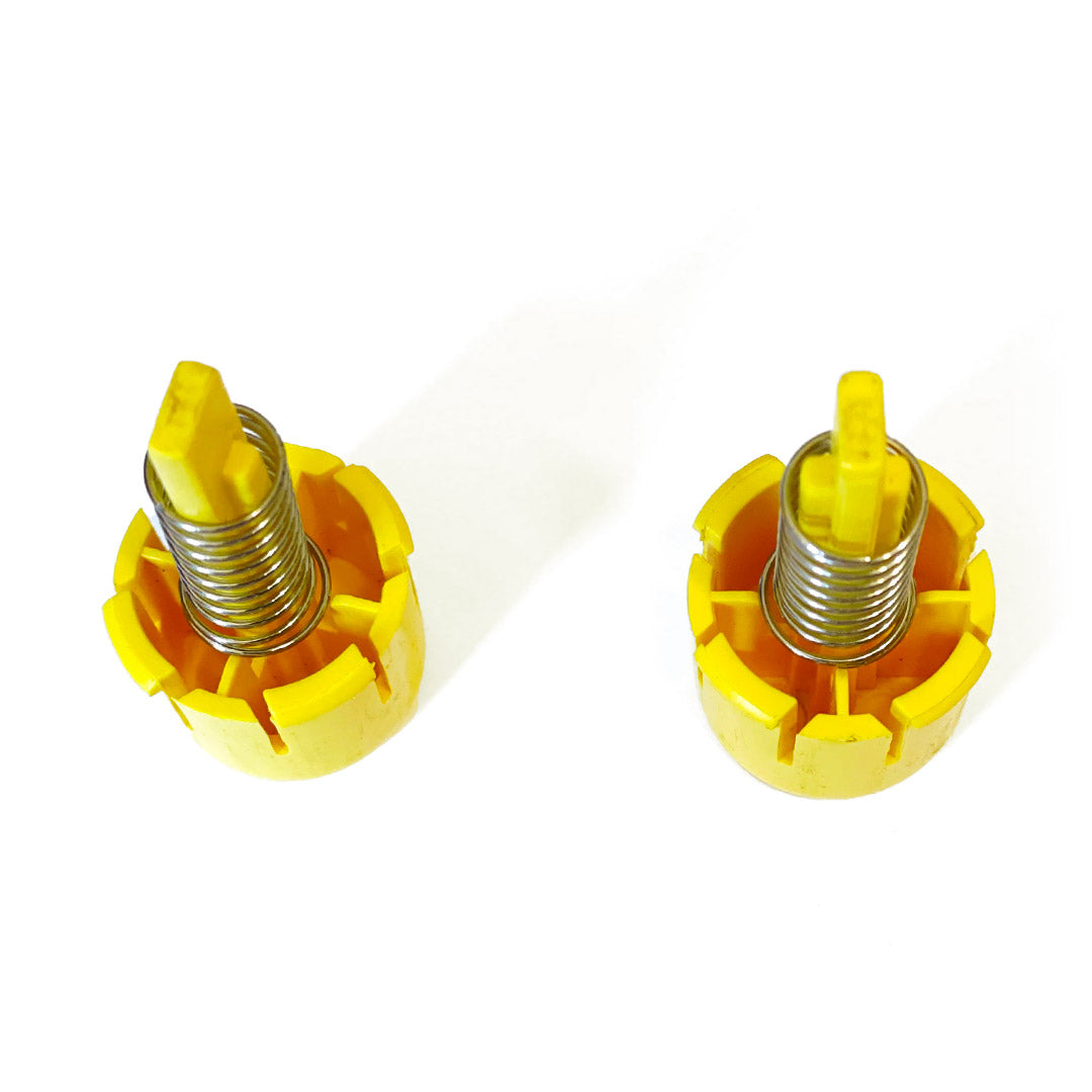 Top-down view of the Aqua Pro Vac yellow replacement buttons, showing the internal springs and structure.